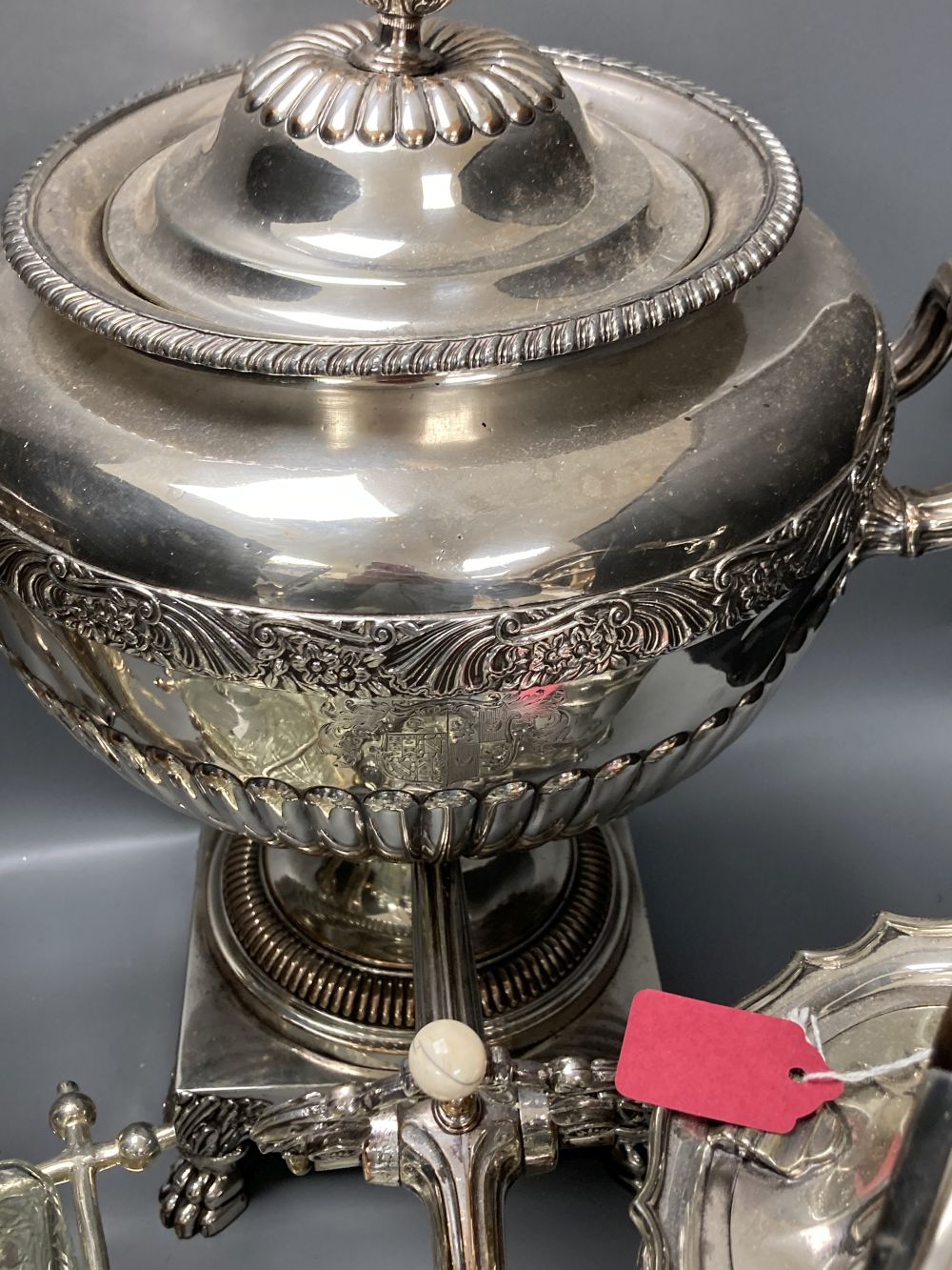 A plated samovar, a kettle on stand, a pair of vases and a three bottle silver plated tantalus and on Old Sheffield plate tea urn, c.18